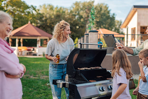 istock Family grilling meat and enjoying drinks in backyard 2208573870