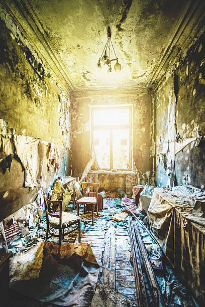 istock Abandoned destroyed room with broken furniture and peeling walls, dramatic sunlight. Horror scene post-apocalyptic interior, vintage destruction 2208577435