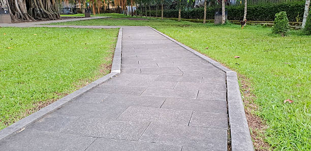 istock Park pedestrian walkway against green grass 2208577763