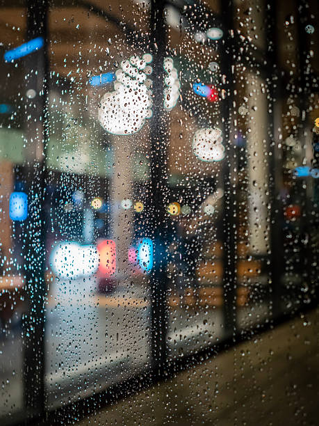 istock Beads of raindrops on a window pane 2208579464