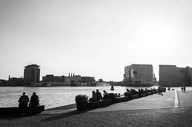 Sunny day along Berlin's Spree River showcasing a bustling promenade, charming architecture, and a cruise boat. The iconic TV tower enhances the captivating city experience.