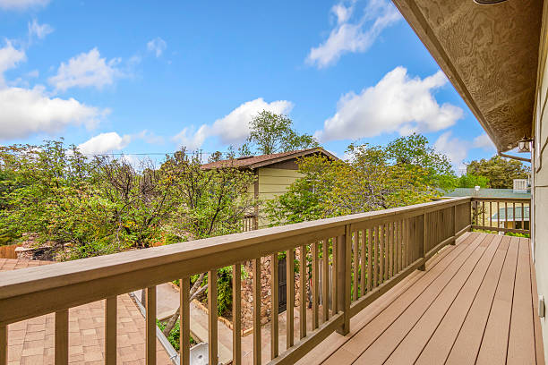 istock A crafted wooden deck with railing and views of a charming house 2208582247