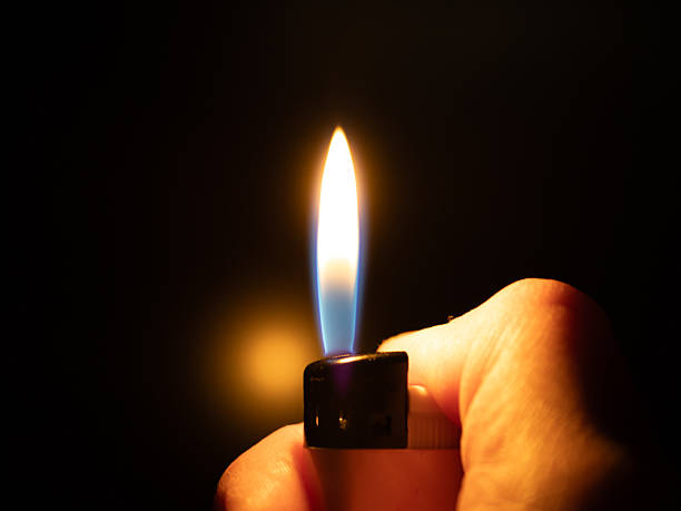 istock A flaming lighter in hand amidst the darkness 2208588552