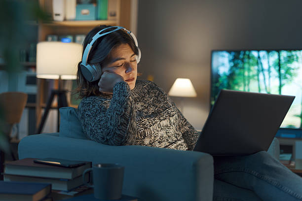 istock Woman falling asleep while watching movies on her laptop 2208594372