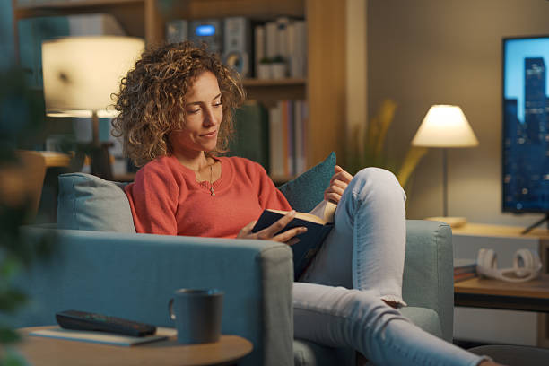 Relaxed woman reading a book at home