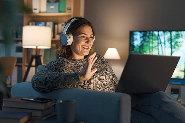 istock Happy woman videocalling her friends online 2208594603