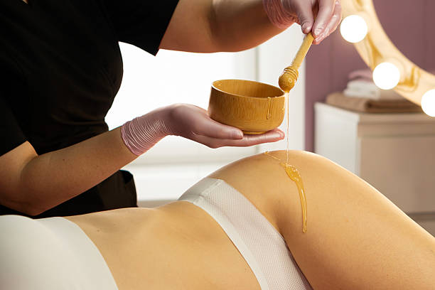 istock Honey flows smoothly from dipper during wellness skin treatment. 2208596292