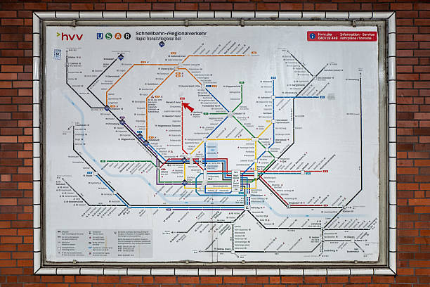Hamburg, Germany. March 30th, 2025: A close-up shot of the HVV (Hamburger Verkehrsverbund) rapid transit and regional rail map displayed at the Niendorf-Nord subway station. The map showcases various train lines and routes, with multiple colorful lines representing the extensive network of Hamburg’s public transportation system. The map is framed within a tiled border, providing a useful guide for commuters.