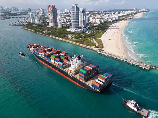 istock Cargo ship with container in Miami, aerial. Freight container on cargo vessel. Cargo ship vessel leaving port. Container ship. Export and import. Cargo business. Port of Miami. Ocean-crossing vessel 2208599984