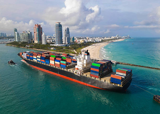 istock Container ship. Export and import. Cargo business. Port of Miami. Cargo ship with container in Miami, aerial. Freight container on cargo vessel. Cargo ship vessel leaving port. Efficient transport 2208600020