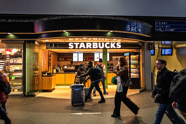 Miami Beach, USA - January 20, 2021: Famous Lincoln road shopping street with sign entrance exterior for Starbucks coffee cafe restaurant store in Florida