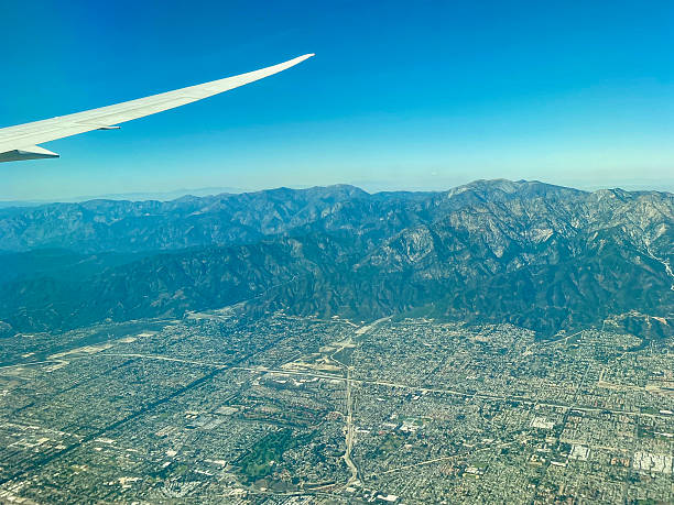 istock Airplane wing flying over Los Angeles 2208605284