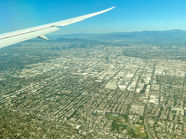 istock Airplane wing flying over Los Angeles 2208605287