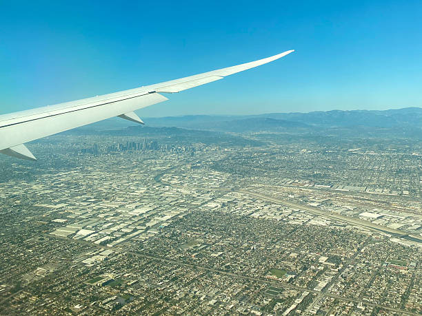 istock Airplane wing flying over Los Angeles 2208605291