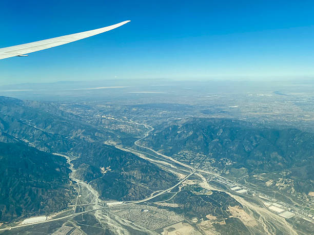 istock Plane wing flying over the USA 2208605299