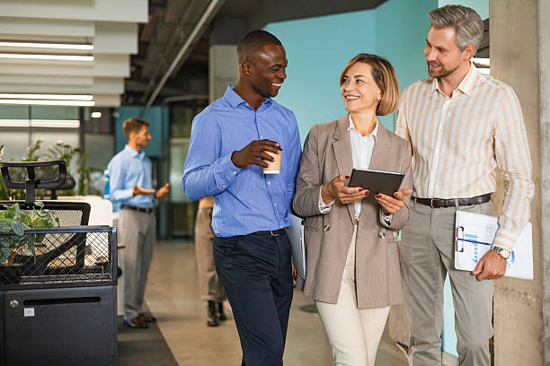 istock Three business people discussing work together using a tablet in a modern office 2208614433