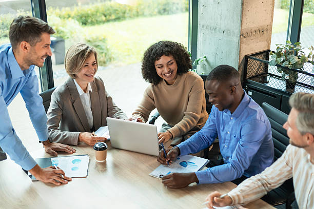 istock Successful businesspeople working in a coworking space working with laptop discussing strategy and business plan in modern office. 2208616673