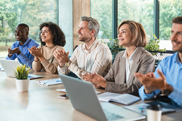 istock Colleagues clapping hands at seminar, listening speaker. Business education 2208616817