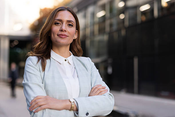 istock Confident businesswoman smiling with folded arms in urban setting 2208617839