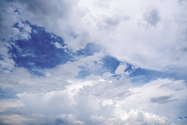 Panoramic view of clear blue sky and clouds, Blue sky background with tiny clouds. White fluffy clouds in the blue sky. Captivating stock photo featuring the mesmerizing beauty of the sky and clouds.