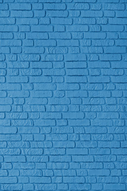 istock Blue color painted brick wall texture, brickwork, masonry of stone blocks vertical background 2208626337
