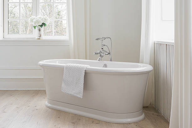 istock Modern elegant minimalist bathroom interior with curtains and window and freestanding bathtub 2208626376