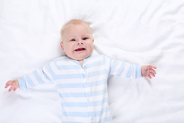 istock Baby boy lying on white bed 2208627222