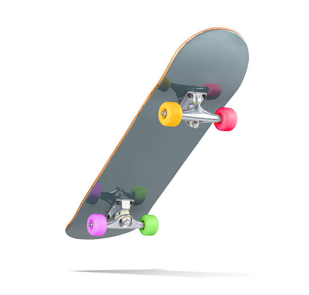 istock A vibrant skateboard with a glossy dark grey deck and multicolored wheels—pink, green, yellow, and red, isolated on white background. File contains a path to isolation 2208631921