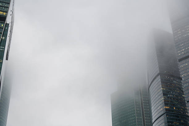 istock Skyscrapers emerging from thick fog creating a mysterious urban landscape 2208633653