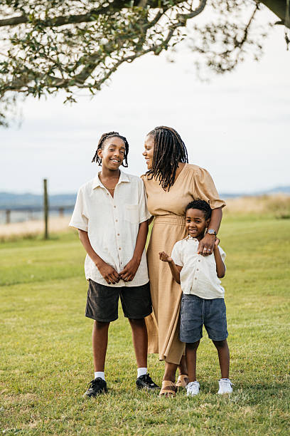 istock A joyful African mother and her smiling young son embracing outdoors in a sunny field, signifying warmth and love 2208635687