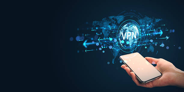 istock Person holding smartphone showing VPN icon with global network data transfer symbol on dark background, representing secure internet connection concept. 2208635985