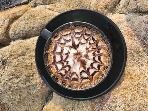Coffee latte art milk foam on stone