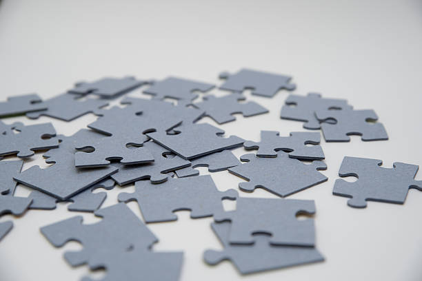 istock monochromatic puzzles in a pile lying on a white background 2208639012
