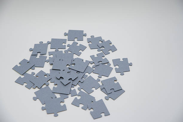 istock monochromatic puzzles in a pile lying on a white background 2208639013