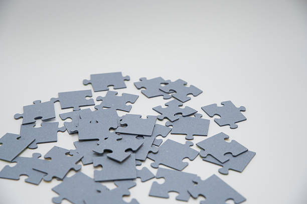 istock monochromatic puzzles in a pile lying on a white background 2208639015