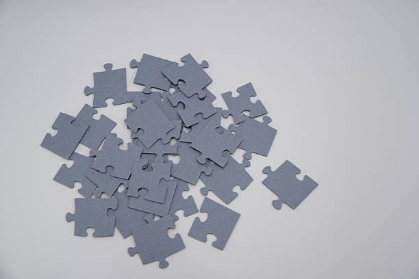 istock monochromatic puzzles in a pile lying on a white background 2208639016