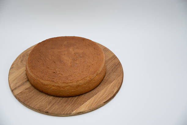 Homemade round sponge cake baked on a white background