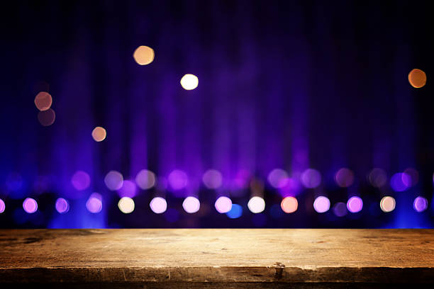 Wooden table and lights during night time. Product display or mock up