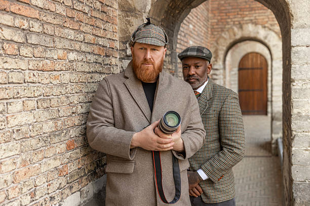 istock Two handsome senior diverse men dressed as classic private detectives 2208644208