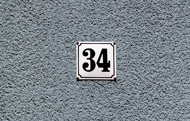 istock house number 34 at a gray plaster wall 2208653452