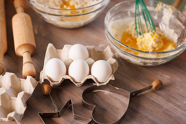 istock Kids baking cookies, mixing flour and eggs with kitchen utensils on a wooden table. 2208653961