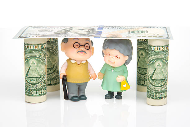 charming scene featuring two elderly figurines a man and woman, standing under a dollar bill roof supported by rolled dollar bills. The playful depiction symbolizes financial security in retirement