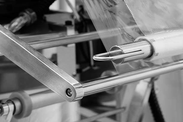 istock Automatic polyethylene plastic bag production machine. Close-up of roller of plastic bag production machine. product packaging industrial concept background 2208656698