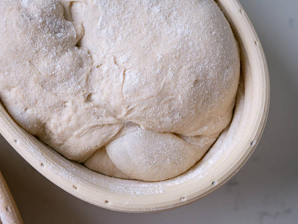 istock Sourdough Bread in Proofing basket, bannetons baskets for retarding raw dough before baking. 2208658761