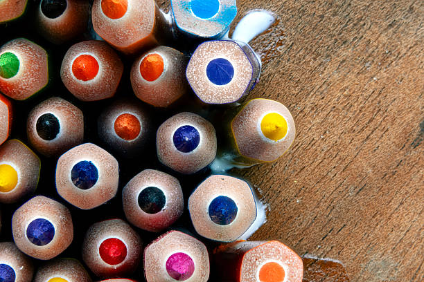 Wooden colored pencils placed forming a circle shape