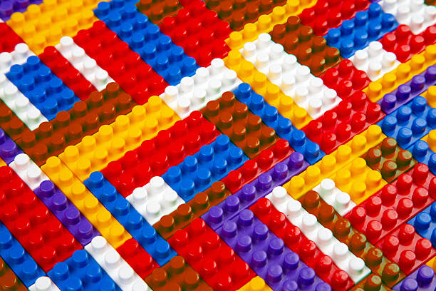 Abstract background texture of colored constructor blocks. Background of colorful plastic part of constructor. Pile of colored toy bricks.