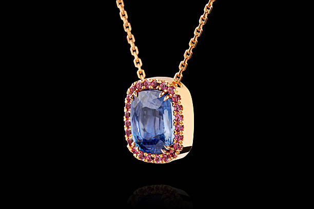 istock gold pendant with sapphire stone and diamonds on black background 2208662052