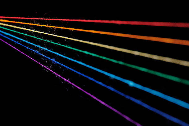 istock multicolored sewing threads in the form of a rainbow on a black background 2208662096