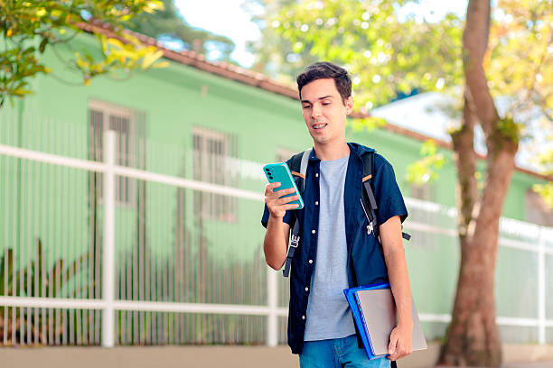 istock Brazilian University Student Using Smartphone Outdoors 2208665808