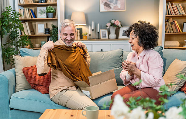 istock Man unboxing a gift from his wife at home 2208666792